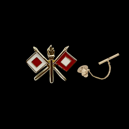 Gold tie tac with red and white flag design on a white background